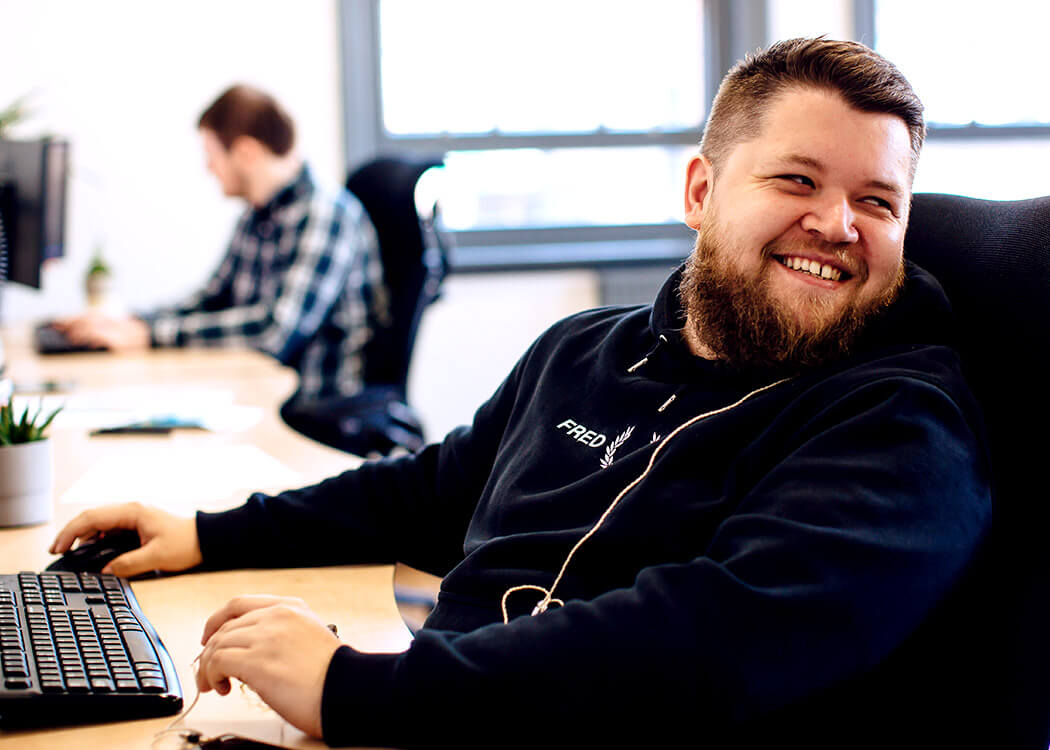 Liam, from Digital Agency Class, looking behind him with a big grin on his face