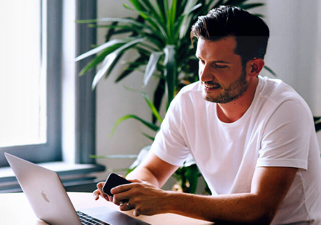 Chris Pyatt from Class reviewing a website design on his laptop