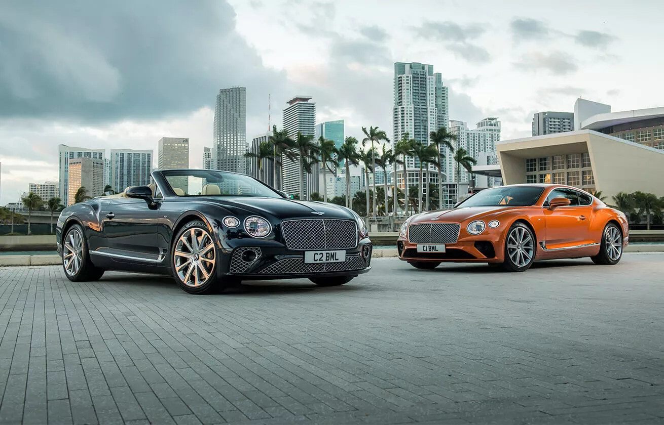 2 Bentleys infront of a city scape