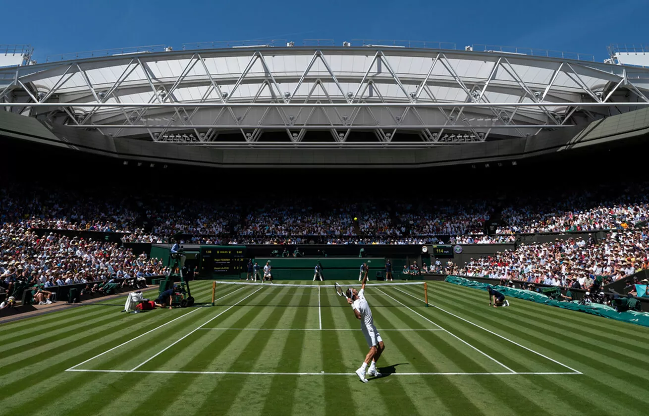 Wimbledon Tennis match, man about to swing Tennis racket