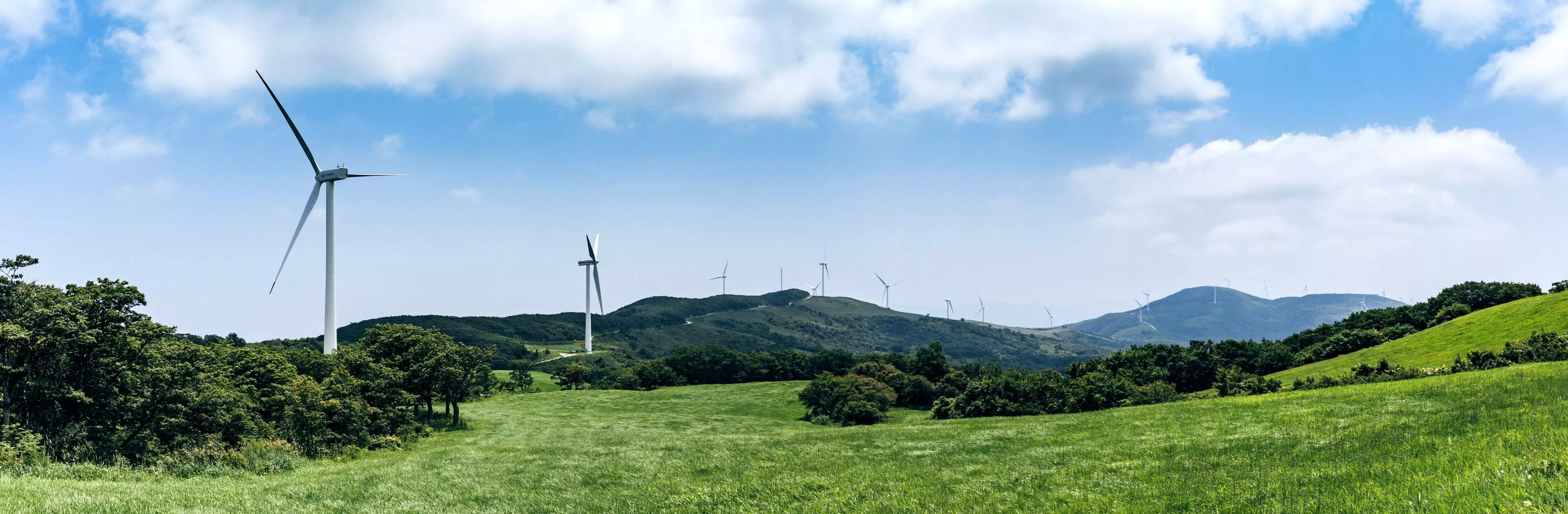 Rolling hills with wind turbines scattered throughout
