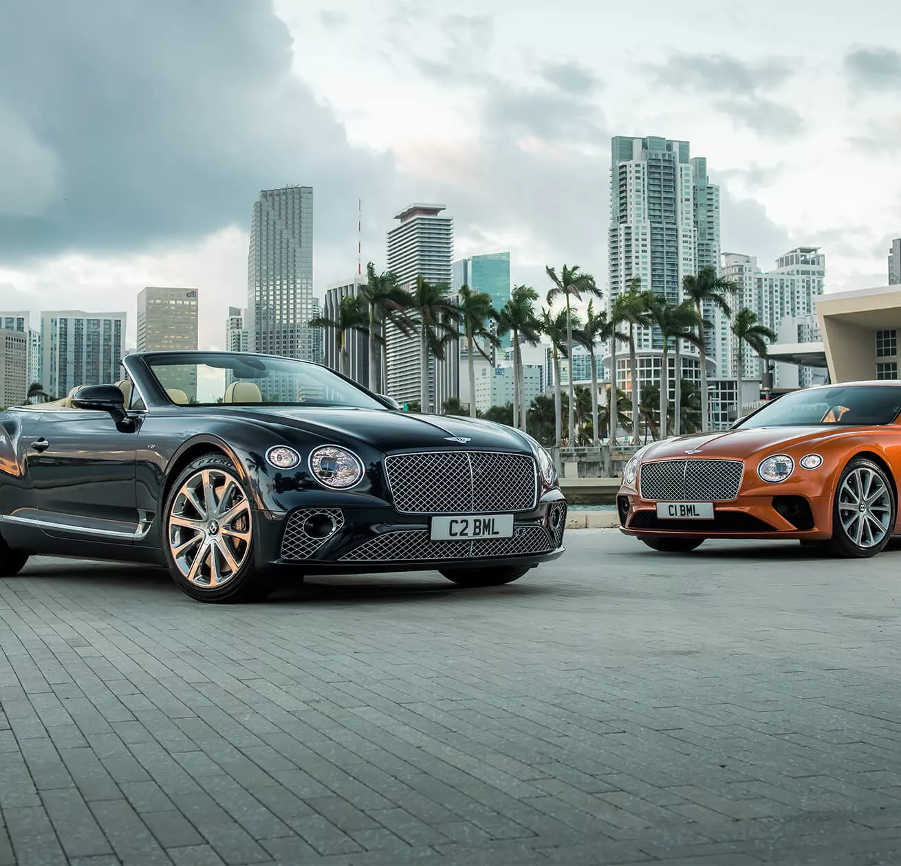 2 Bentleys infront of a city scape