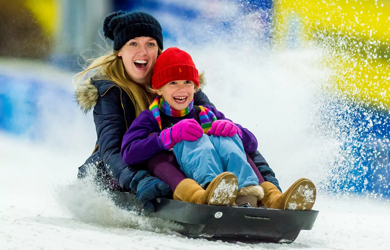 Mom and daughter sledging